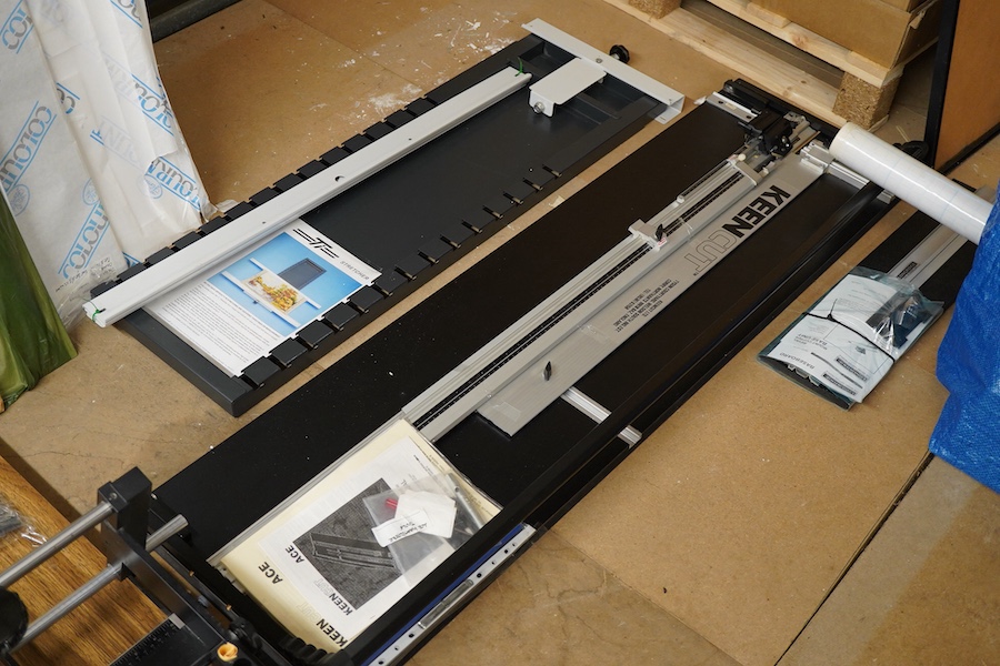 A collection of framing equipment to include Ademco heat press, C & H Bainbridge oval master mount cutter, Longridge baseboard, various mount and backing boards, tools, cutters, clamps and point drivers, many with instru